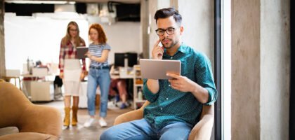 The best ways to do market research. Image describes a man thinking about marketing while watching his tablet.